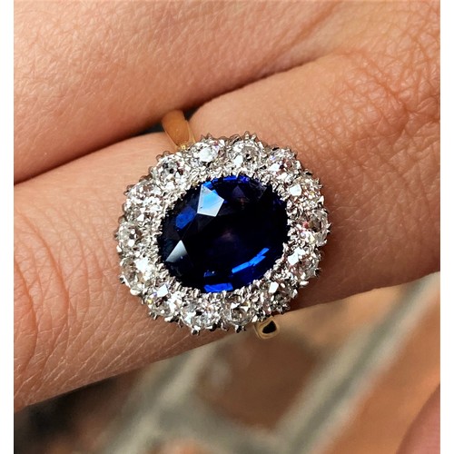 255 - A sapphire and diamond cluster ring, the central oval, mixed cut sapphire (measuring approx 3.16ct),... 