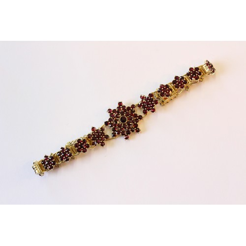 222 - A suite of Bohemian garnet set silver gilt jewellery, to include a pair of floral cluster drop earri... 