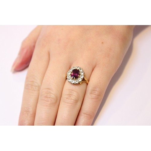 289 - A pink stone and diamond cluster ring, comprising a central untested oval mixed cut stone (probably ... 