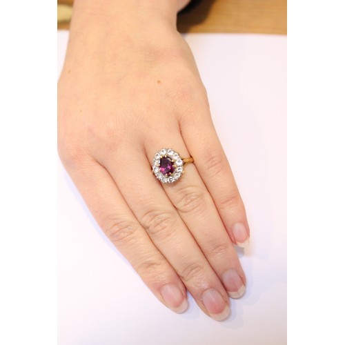 289 - A pink stone and diamond cluster ring, comprising a central untested oval mixed cut stone (probably ... 