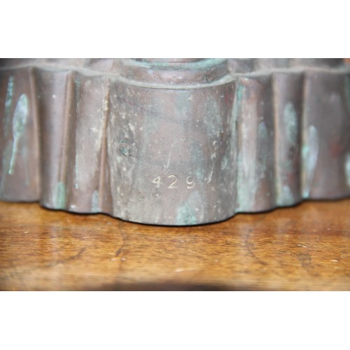 319 - Four 19th century copper estate jelly moulds, each of varying form to include three castellated exam... 