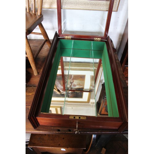 854 - An early 20th century mahogany wall display cabinet, with a single lockable door enclosing a mirrore... 