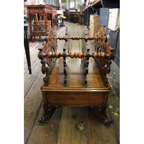 825 - A Victorian figured walnut Canterbury, the outer carved foliate open work dividers flanking a pair o... 