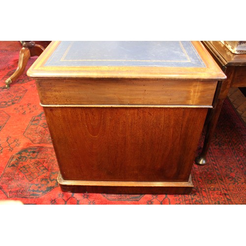 858 - An Edwardian mahogany and satinwood crossbanded twin pedestal desk, the rectangular moulded top with... 