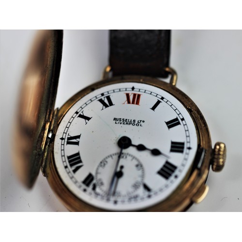 144 - A gent's vintage 9ct gold half hunter wristwatch by Russells Ltd, the round white enamel dial with R... 