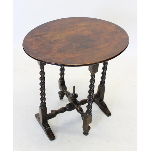 1000 - A 19th oak folding occasional table, the circular top raised upon barley twist legs extending to tre... 