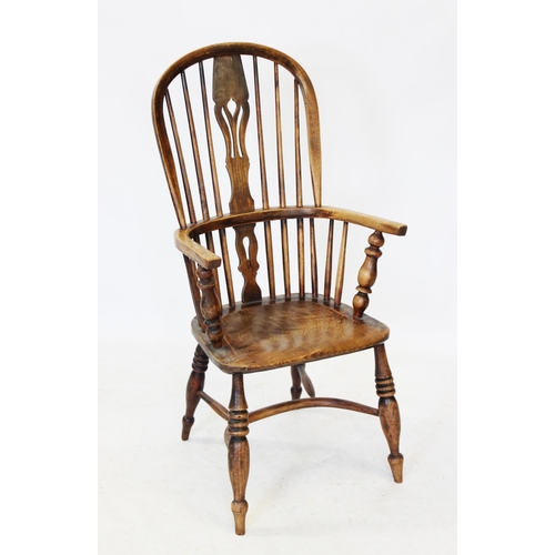 1009 - A 19th century elm and ash hoop back Windsor farmhouse elbow chair, with a central pierced splat abo... 