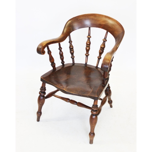 1012 - A 19th century elm and beech wood smokers bow elbow chair, the curved top rail extending to down swe... 