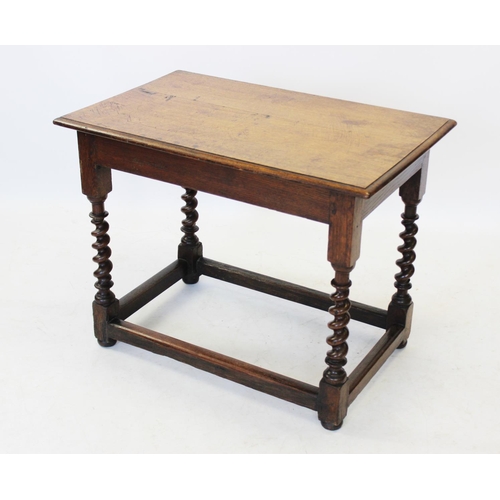 1013 - A 17th century style oak side table, 19th century, the rectangular moulded top raised upon barley tw... 