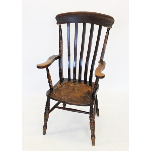 1014 - A Victorian elm and beech wood Windsor farmhouse elbow chair, the lath back above a shaped elm seat,... 