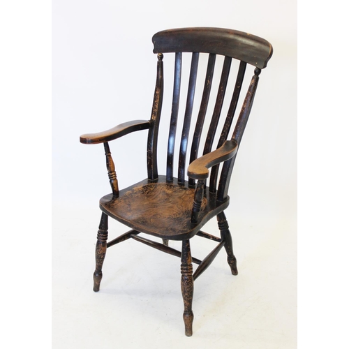 1014 - A Victorian elm and beech wood Windsor farmhouse elbow chair, the lath back above a shaped elm seat,... 