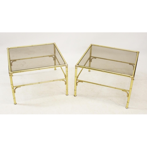 1048 - A pair of mid 20th century gilt metal and smoked glass lamp tables, the square glass tops supported ... 