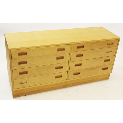 1049 - A mid 20th century teak chest, with eight drawers upon an inverted plinth base, 67cm H x 139cm W x 4... 