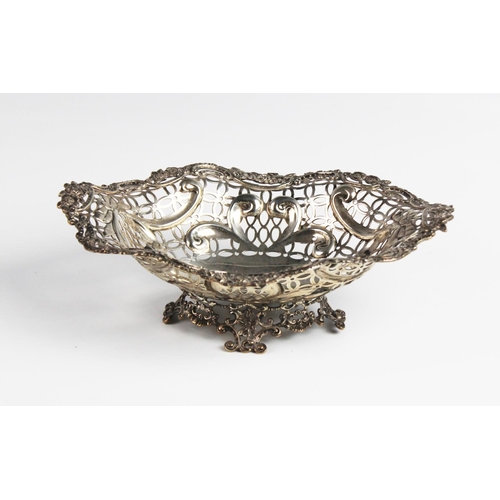 127 - A Victorian silver pedestal dish by William Comyns, London 1891, of oval form with moulded scrolling... 