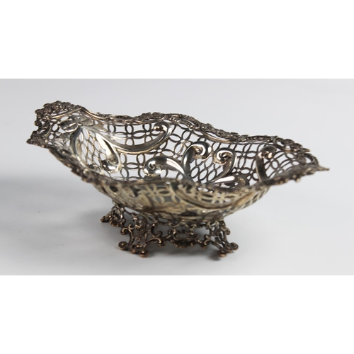 127 - A Victorian silver pedestal dish by William Comyns, London 1891, of oval form with moulded scrolling... 