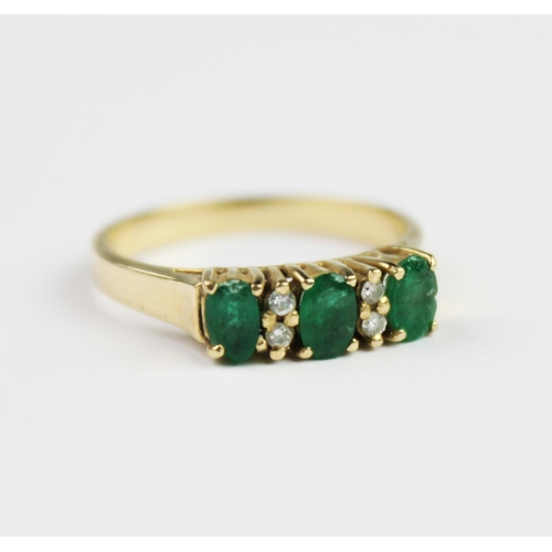 199 - An emerald and diamond ring, comprising three mixed cut oval emeralds each measuring 4.7mm x 3mm, in... 