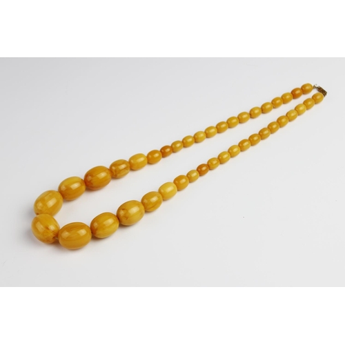 214 - A butterscotch amber beaded necklace, comprising forty-one graduated polished amber beads, (measurin... 