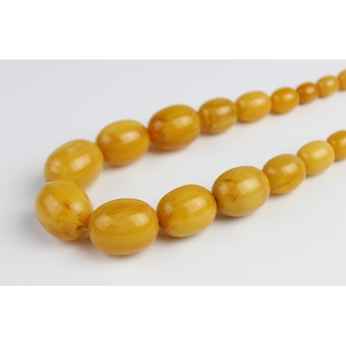 214 - A butterscotch amber beaded necklace, comprising forty-one graduated polished amber beads, (measurin... 