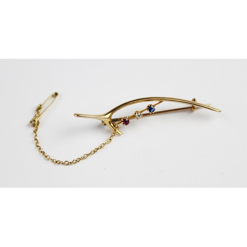 215 - A Victorian diamond, sapphire and ruby 'jubilee' wishbone brooch, comprising an old cut diamond, sap... 