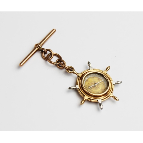 220 - A Victorian 15ct gold fob compass in the form of a ship's wheel, the reverse decorated with enamel m... 