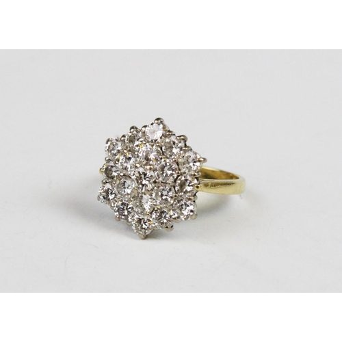 310 - A diamond cluster ring, the hexagonal shaped cluster comprising nineteen round brilliant cut diamond... 