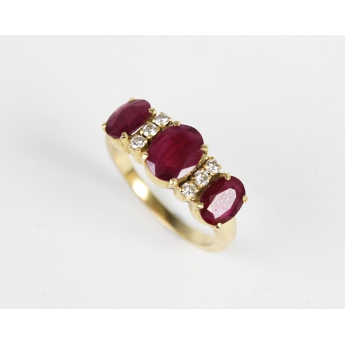 313 - A ruby and diamond dress ring, comprising a central oval cut ruby measuring 8mm x 6mm, with a furthe... 