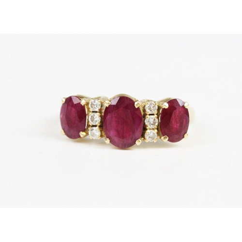 313 - A ruby and diamond dress ring, comprising a central oval cut ruby measuring 8mm x 6mm, with a furthe... 