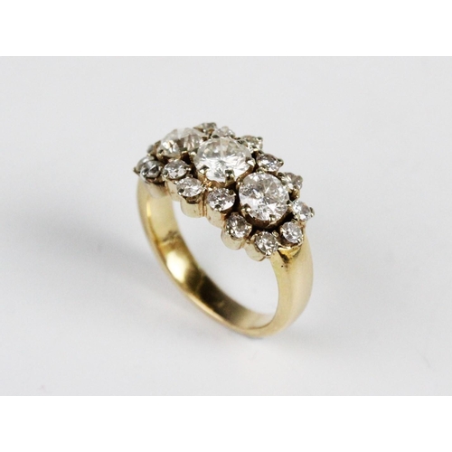 314 - A diamond cluster ring, comprising a central round brilliant cut diamond weighing approx. 0.75 carat... 