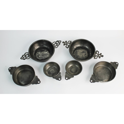 389 - A set of four pewter porringers, probably 18th century, comprising: two small single handled example... 