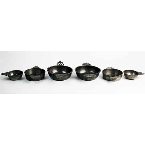 389 - A set of four pewter porringers, probably 18th century, comprising: two small single handled example... 