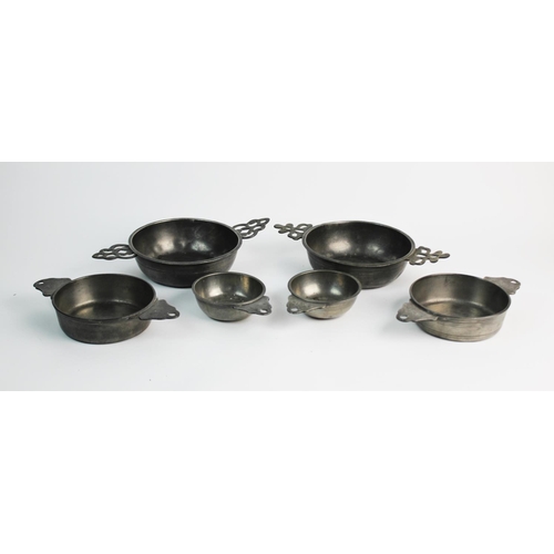 389 - A set of four pewter porringers, probably 18th century, comprising: two small single handled example... 