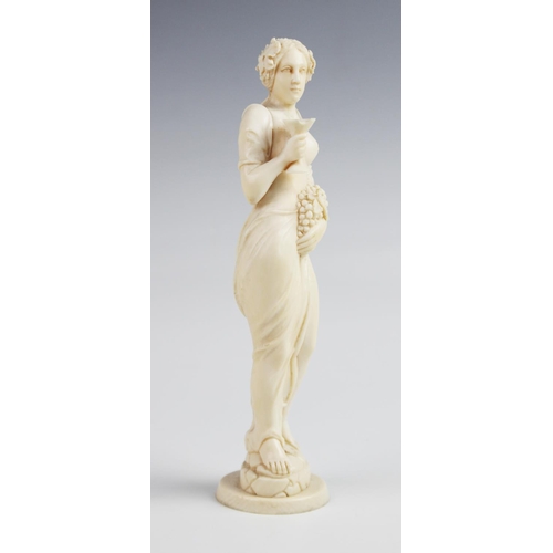 393 - A late 19th century Dieppe carved ivory bacchanalian figure, possibly a Maenad, modelled as a scanti... 