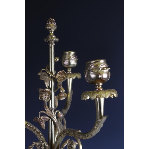 402 - A pair of bronze and gilt metal figural candlesticks, 19th century, each designed as a classical mai... 