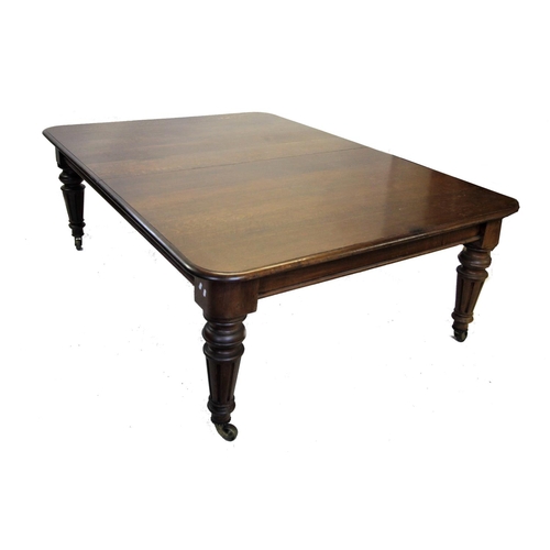 964 - A Victorian oak extending dining table, the rectangular moulded top with rounded corners above a pla... 