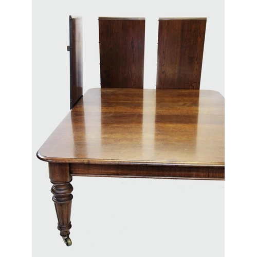 964 - A Victorian oak extending dining table, the rectangular moulded top with rounded corners above a pla... 