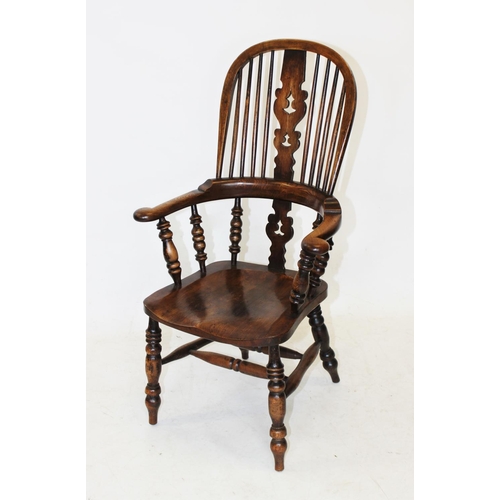 986 - A 19th century ash and elm hoop back Windsor farmhouse elbow chair, the central pierced splat above ... 