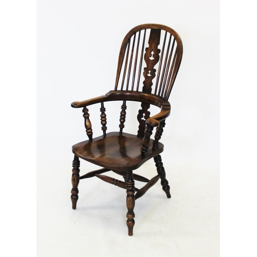 986 - A 19th century ash and elm hoop back Windsor farmhouse elbow chair, the central pierced splat above ... 