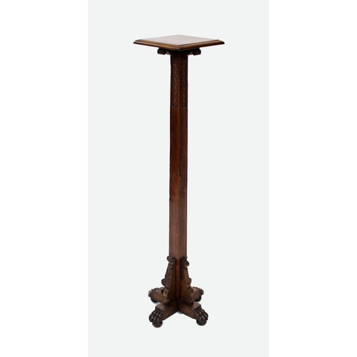 988 - An early 20th century oak torchere, the square moulded top supported on scroll capitals and a taperi... 