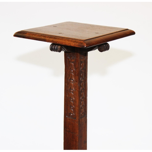 988 - An early 20th century oak torchere, the square moulded top supported on scroll capitals and a taperi... 