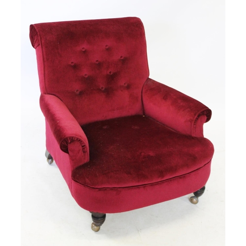 998 - A Victorian claret upholstered arm chair, the deep set button back above padded scrolled arms and a ... 