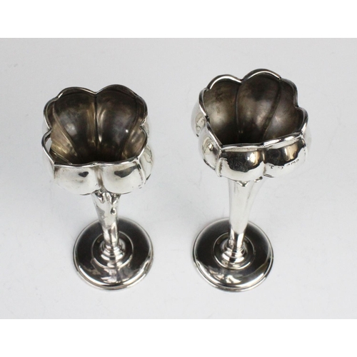 106 - A pair of Edwardian silver tulip form posy vases by Synyer & Beddoes, Birmingham 1901, each on weigh... 