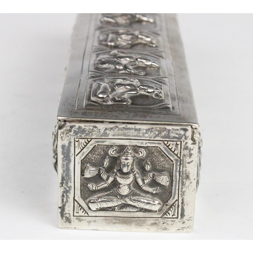 107 - A Burmese white metal box of rectangular form with embossed decorative panels to cover and sides dep... 