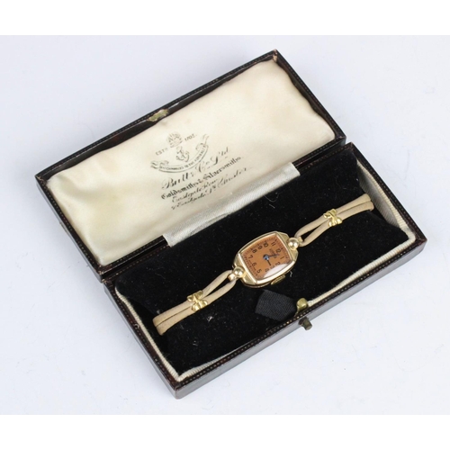 172 - A lady's vintage 14ct gold Roamer wristwatch, the bronze toned tonneau shaped dial with Arabic numer... 