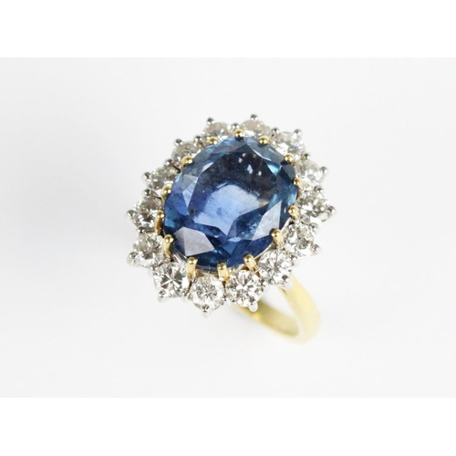 258 - A sapphire and diamond cluster ring, the central untested oval mixed cut sapphire (measuring 12.54mm... 