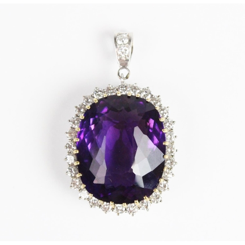 259 - An amethyst and diamond pendant, the central cushion cut amethyst measuring approx. 28mm x 23mm x 17... 