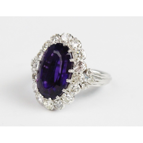 260 - An amethyst and diamond cocktail ring, the central oval step cut amethyst (measuring 15.5mm x 10mm x... 