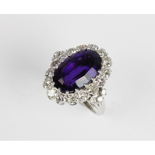 260 - An amethyst and diamond cocktail ring, the central oval step cut amethyst (measuring 15.5mm x 10mm x... 