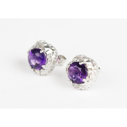 261 - A pair of amethyst set 9ct gold stud earrings, each comprising a round mixed cut amethyst measuring ... 