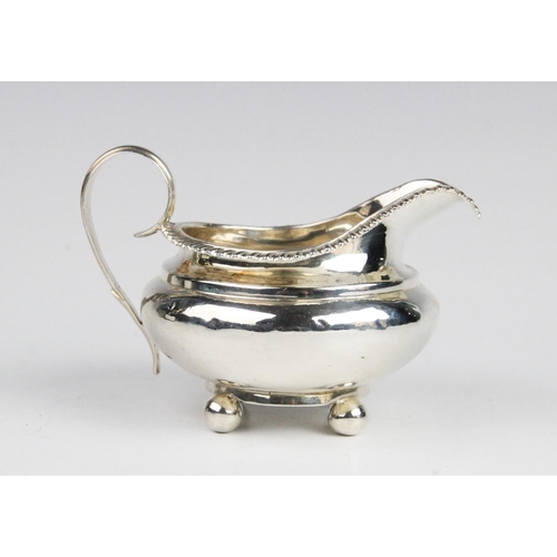 37 - A George IV silver milk jug, marked for London (maker's mark and date letter worn), of compressed fo... 
