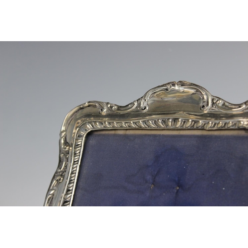 43 - An Edwardian silver mounted photograph frame, Birmingham 1909 (maker's marks worn), of rectangular f... 